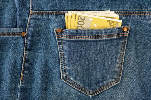 A stack of 200 euro bills in a jeans pocket. Money in the back pocket of my jeans. The concept of investment, cash, wealth and profit. copyspace