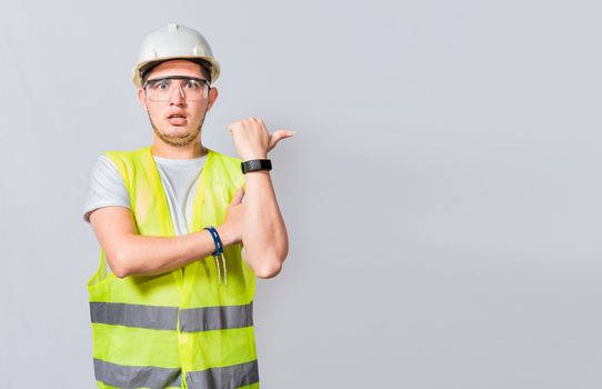 Amazed Engineer pointing to side. Surprised engineer pointing finger to the right, Surprised engineer pointing to the side, Surprised face construction worker pointing at an advertisement