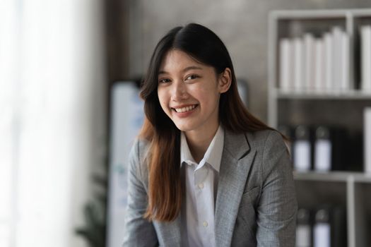 Smart asian business woman smiling at office space. real estate, lawyer, non-profit, marketing concept.