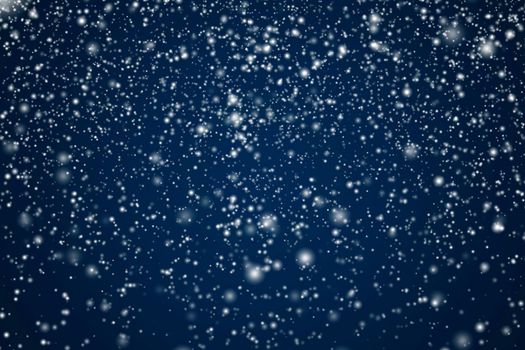 Winter holidays and wintertime background, white snow falling on dark blue backdrop, snowflakes bokeh and snowfall particles as abstract snowing scene for Christmas and snowy holiday design, copyspace