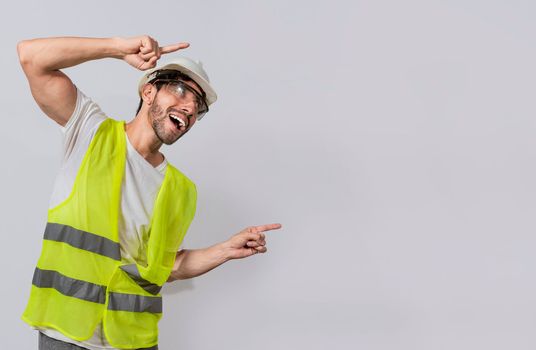 Builder engineer pointing finger to the right isolated, Construction engineer with vest pointing at an advertisement. Engineer man pointing to side. Smiling engineer man pointing aside