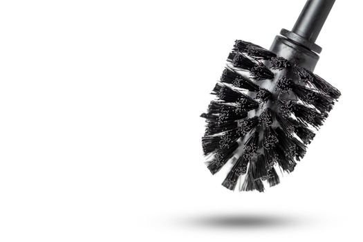Black toilet brush isolated on white. Close-up of a toilet cleaning brush with metal elements to insert into a project or design. Metal brush for the toilet on a white background
