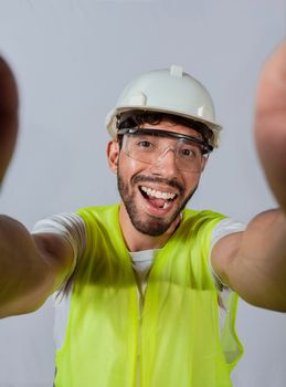 Funny builder engineer taking a selfie isolated, Engineer taking a selfie isolated. View of male engineer taking a selfie isolated, Smiling male engineer taking a selfie looking at camera