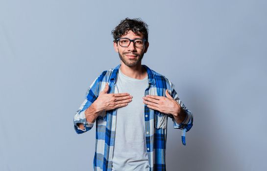 Smiling person gesturing the word HAPPINESS in sign language, Interpreter man gesturing the word HAPPINESS in sign language. Young man gesturing THANKFUL in sign language