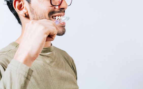 Face of person brushing teeth isolated with copy space. Man brushing his teeth isolated, Face of handsome man brushing his teeth with copy space. Tooth care and brushing concept