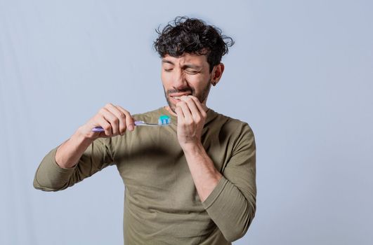 Person with gingivitis holding toothbrush. People holding toothbrush with gum pain. Man holding toothbrush with gum pain, People holding toothbrush with gum problem isolated