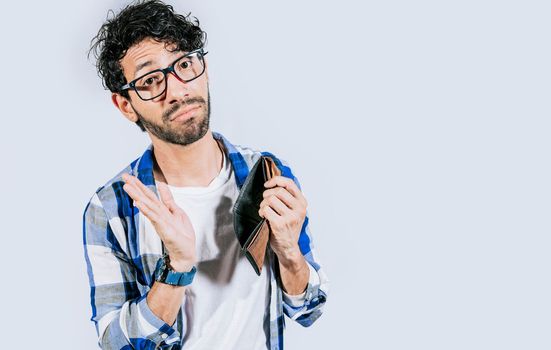 Sad person showing an empty wallet. Man with financial problems shaking wallet. Moneyless frustrated person concept. Sad man shaking an empty wallet