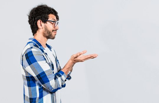 Smiling person recommending a product with his hands, Man recommending an advertisement with the palm of his hands. Guy recommending an ad space isolated
