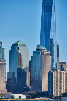 Image of Detail of New York City skyscrapers vertical with reflective glass and blue sky