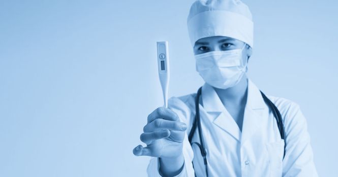 Young female doctor showing thermometer over white background with copy space