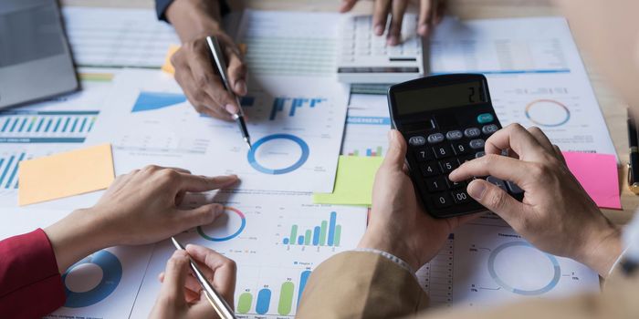 Business financial, accountant discussing with partner are meeting to audit finance planning sales to meet targets set in next year. stock market concept....