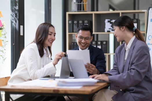 Group of young asian modern people in smart casual wear having a brainstorm meeting. Group of young asian business people discussing in the meeting...