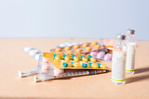 Close up of variety of medicines isolated, Concept of addiction to medicines and syringes. Concept of inappropriate use of medicines. Medicines, pills and syringes on isolated background