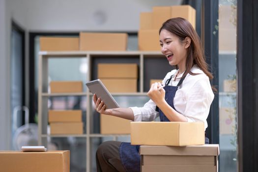 Successful entrepreneur business woman with online sales and Parcel shipping in her home office...