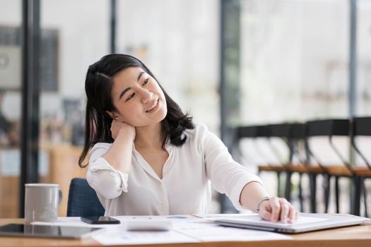 business woman work from home and stretching her body because feel tired after working on tablet computer, Lifestyle woman relax after working at home concept...