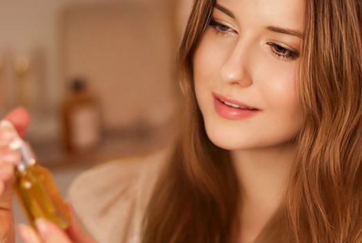 Beautiful woman with organic oil serum bottle, evening beauty and skincare routine.