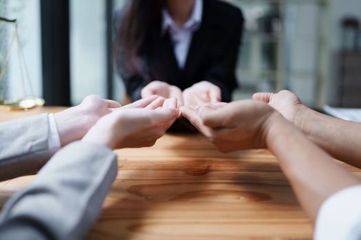 Law, consultation, agreement, contract, lawyer or attorney shakes hands to agree on the client's offer to be hired to fight the parties in court