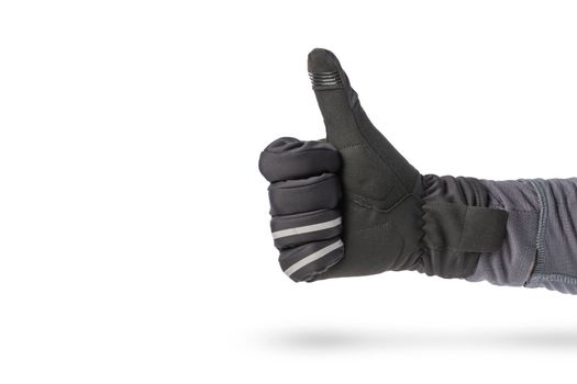 Hand in a glove of a cyclist or motorcyclist. Hand in black glove isolated on white background showing thumb up or showing like