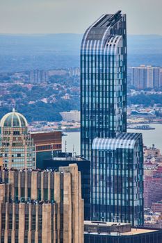 Image of Vertical of New York City skyscraper detail from high up with curved top and blue glass