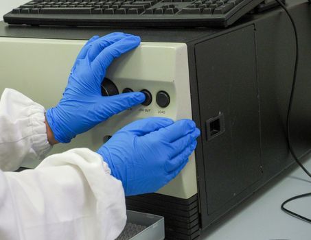 scientific researcher or doctor using looking at a clear solution in a laboratory