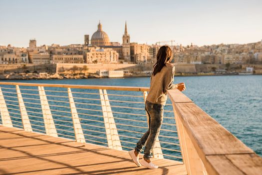 Valletta Malta city Skyline, colorful house balcony Malta Valletta city, young Asian woman visit Malta during a vacation