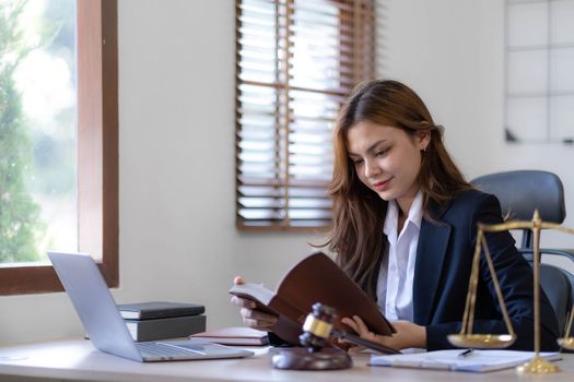Beautiful asian woman lawyer working and gavel, tablet, laptop in front, Advice justice and law concept