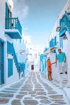 couple on vacation, Mykonos Greece, Little Venice Mykonos Greece, sunset at ocean fron at Mykonos town Europe during summer vacation
