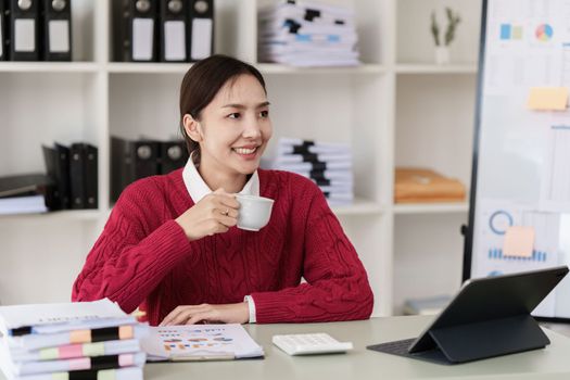 Pleasant positive business woman using digital tablet at home office.