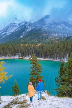 Minnewanka lake Canadian Rockies in Banff Alberta Canada with turquoise water is surrounded by coniferous forests. Lake Two Jack in the Rocky Mountains of Canada. couple hiking by lake Banff Canada