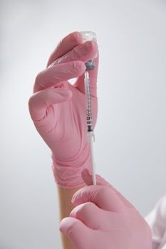 Cropped shot of doctor hands holding a syringe and bottle of vaccine. Ready for injection vaccine.