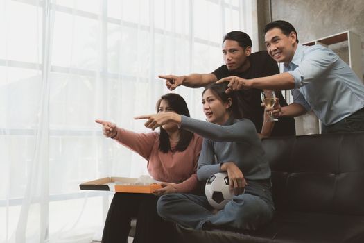 Excited friends having fun by watching football or soccer match and eating pizza at home. Friendship, leasure, rest, home party football, Soccer concept.