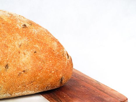 Olive loaf, olive bread, a bread laced with whole olives on white background