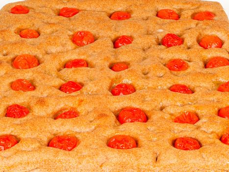 Italian flat bread organic wholewheat focaccia with tomatoes isolated in studio over a background