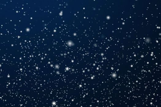 Winter holidays and wintertime background, white snow falling on dark blue backdrop, snowflakes bokeh and snowfall particles as abstract snowing scene for Christmas and snowy holiday design, copyspace