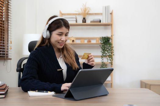 Young Asian business woman using smartphone and credit card for online shopping. Online Payment