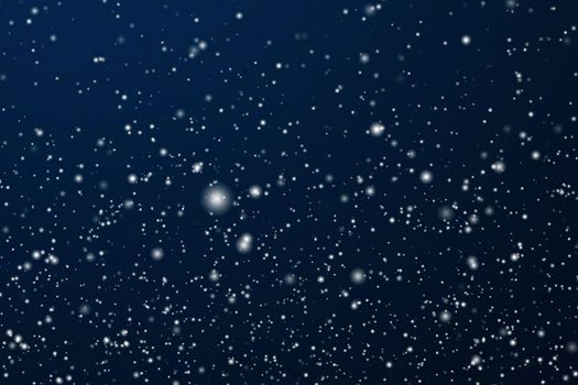 Winter holidays and wintertime background, white snow falling on dark blue backdrop, snowflakes bokeh and snowfall particles as abstract snowing scene for Christmas and snowy holiday design, copyspace