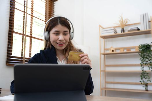 Young Asian business woman using smartphone and credit card for online shopping. Online Payment