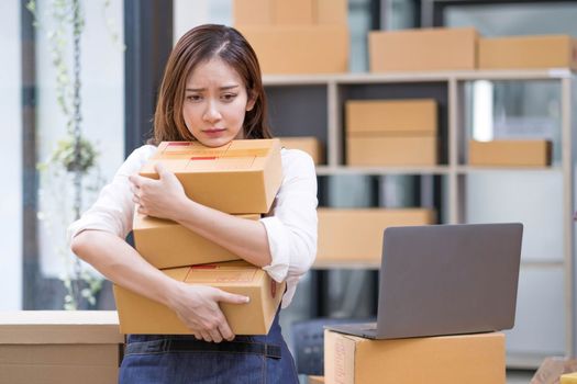 Young Asian business entrepreneur stress in online business, failure woman with working problem. SME entrepreneur and Online selling concept...