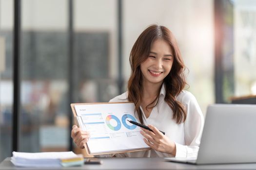 Businesswoman presenting charts and graphs on video call online. Asian Business woman having conference call with client on laptop. Closeup business woman working laptop computer indoor...