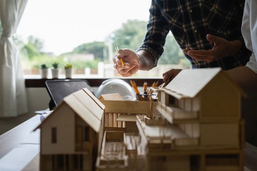 Architect man working with blueprints for architectural plan, engineer sketching a construction project concept.