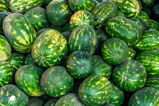 Watermelons in a pile at the market. High quality photo