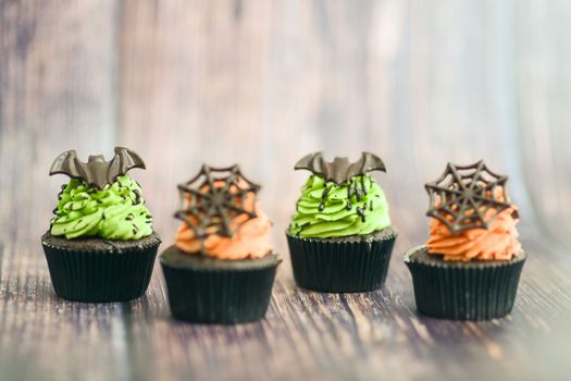 artisan chef preparing handmade with icing and chocolate spider vampire topper