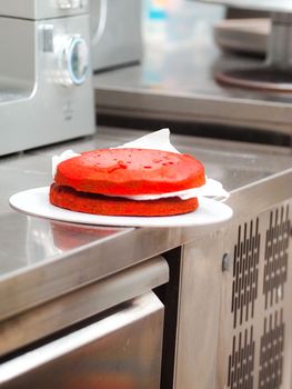 Chef cake designer preparing layered creamy cake base for frosted decoration and topping