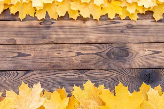 Autumn leaves frame on one down and up side wooden background top view Fall Border yellow and Orange Leaves vintage wood table Copy space. Mock up for your design. Display for product or text