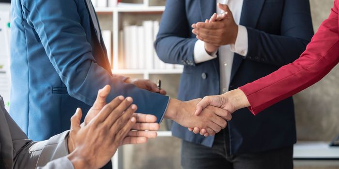 Business handshake for teamwork of business merger and acquisition,successful negotiate,hand shake,two businessman shake hand with partner to celebration partnership and business deal concept...