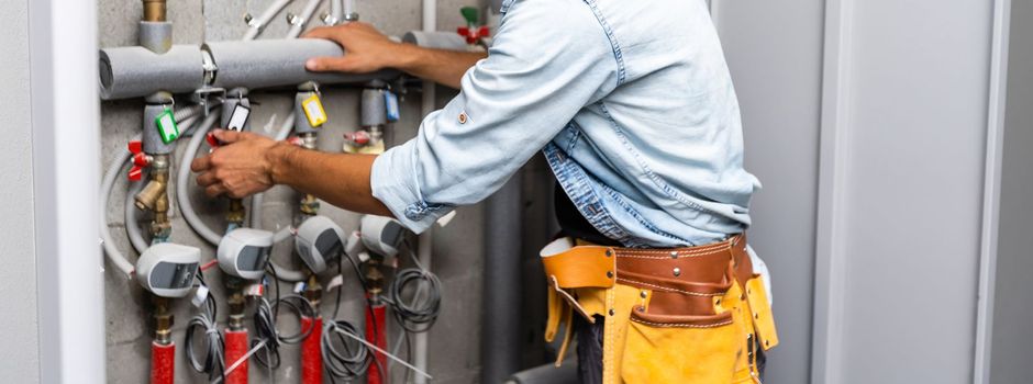 Plumber Repairing Water Pipes In Residential Building.