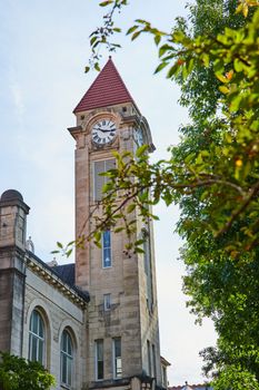 Image of Stunning limestone clock tower on college campus in Bloomington