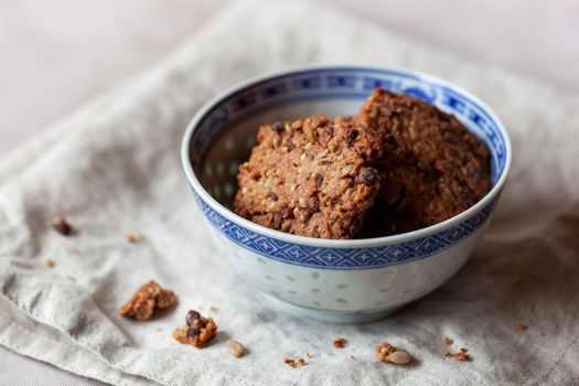 homemade natural ingredients biscuits with seeds and graines, served in a blue bowl