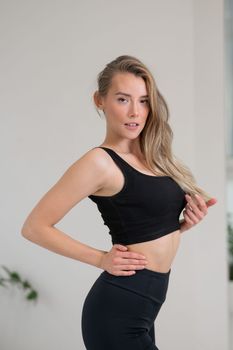 Portrait of a beautiful caucasian woman in black sportswear