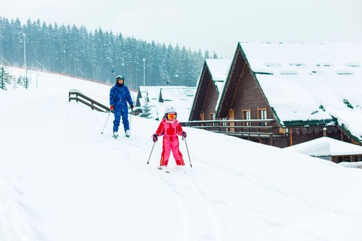 Image of sporty family spending time on winter resort during vacations